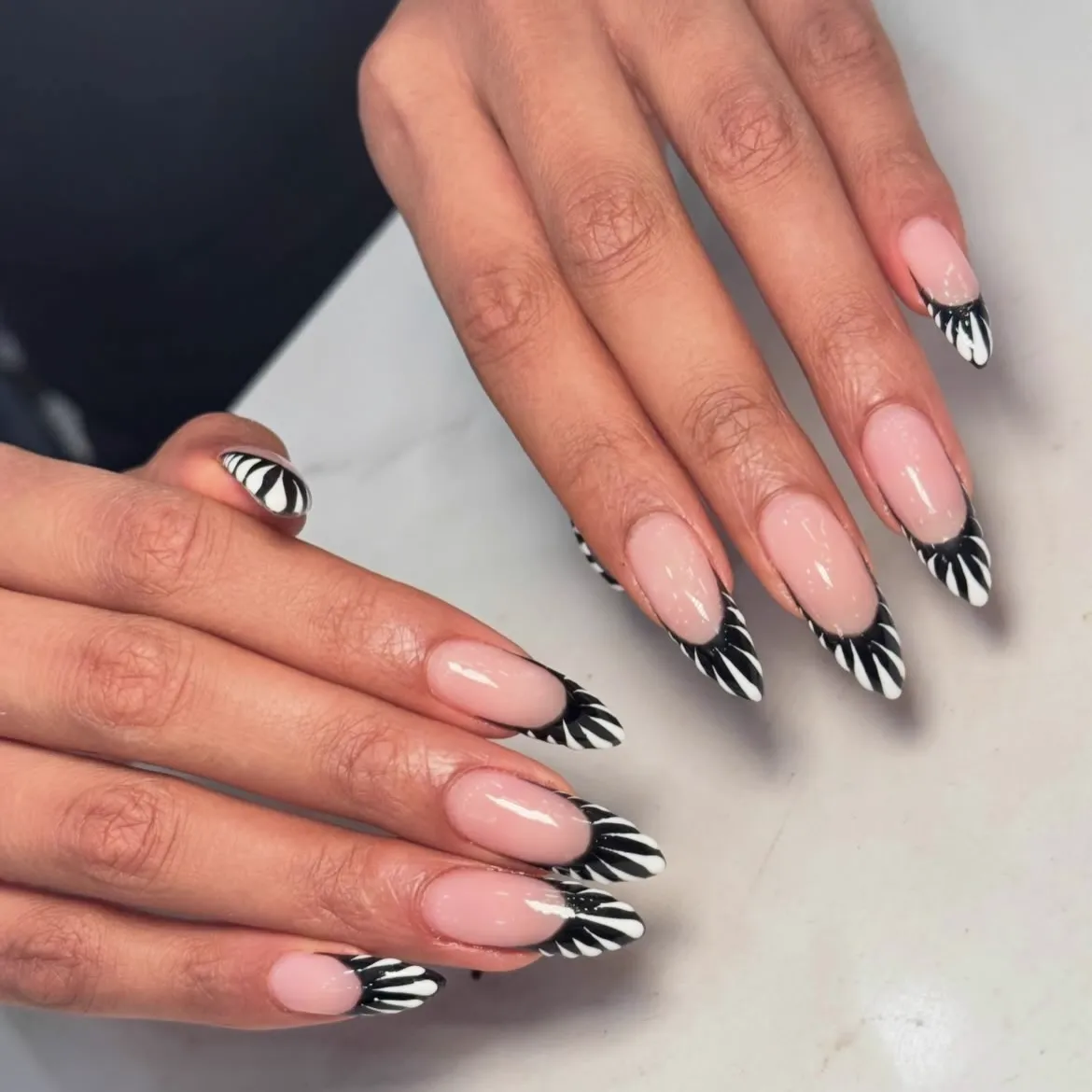 Sheer nails with black brushed French tips and airbrushed edges