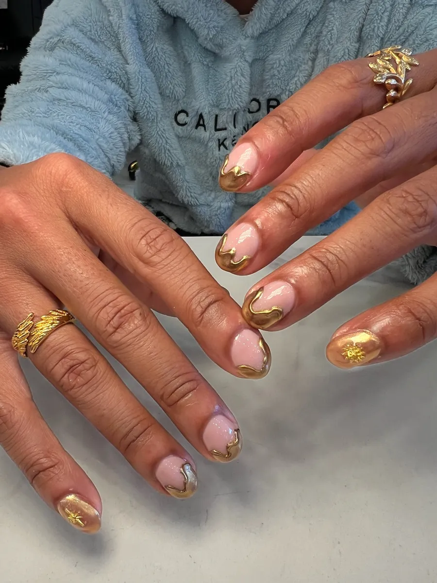 Short almond nails with gold chrome French tips