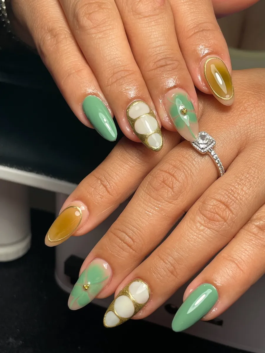 Almond nails in mint green and amber with pearl white 3D detail