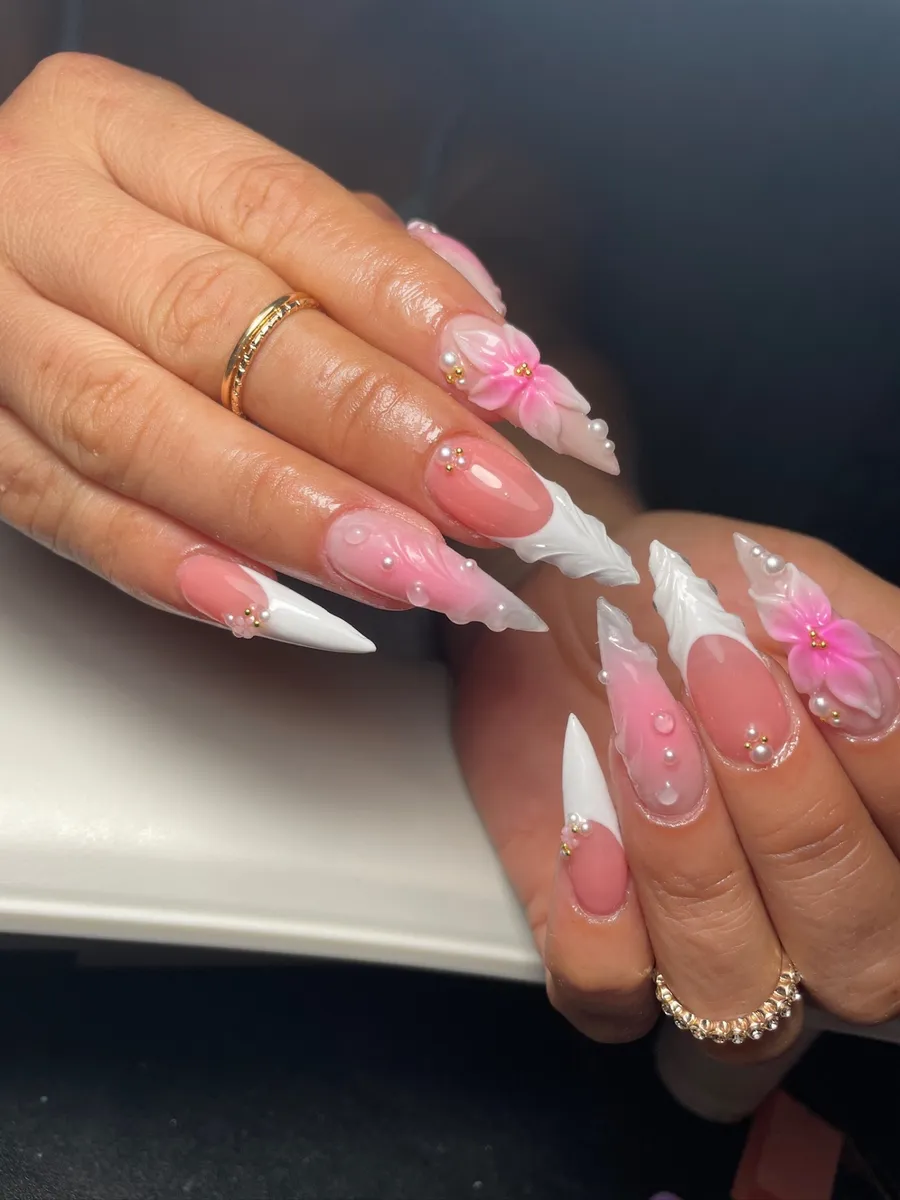 Pink stiletto nails with white French tips, 3D flowers and pearls