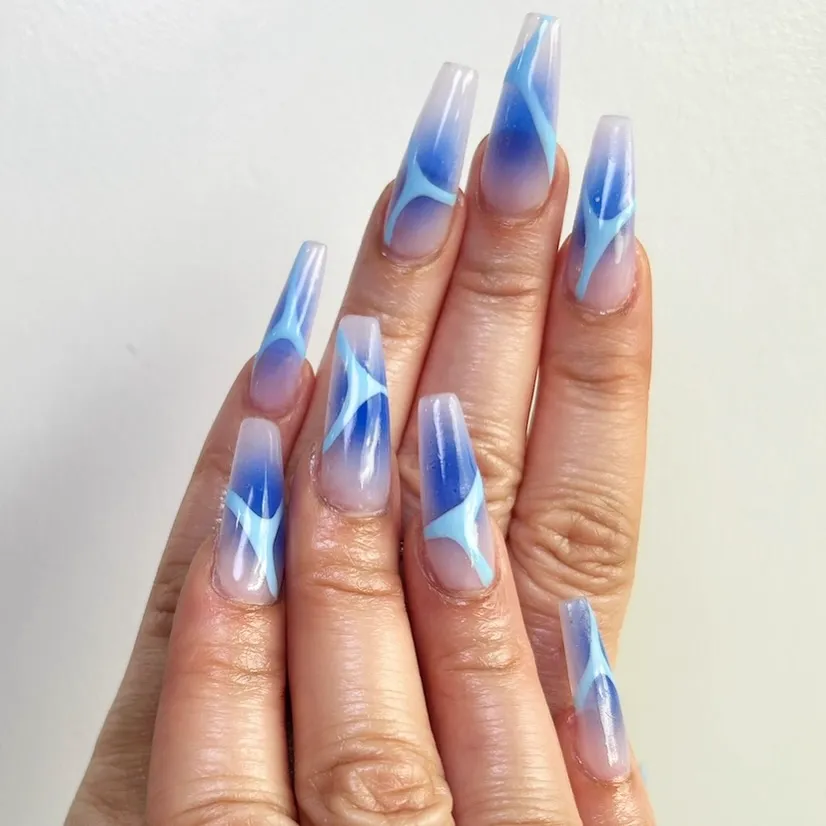 Coffin nails with cobalt blue abstract brushstroke art over a sheer base