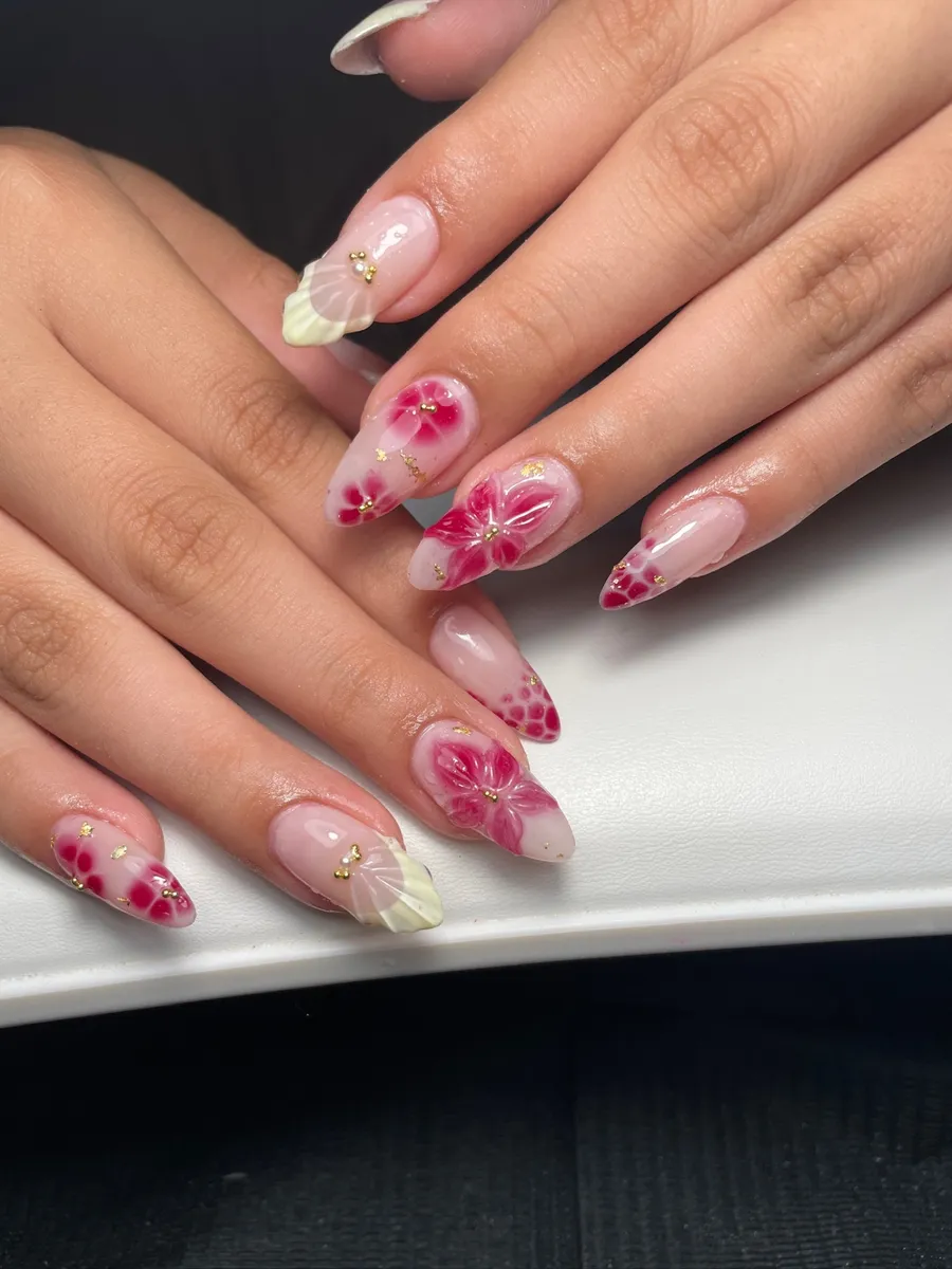 Sheer almond nails with hand-painted pink flowers and dots