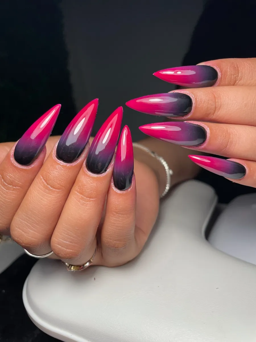 Stiletto nails with hot pink to black ombre