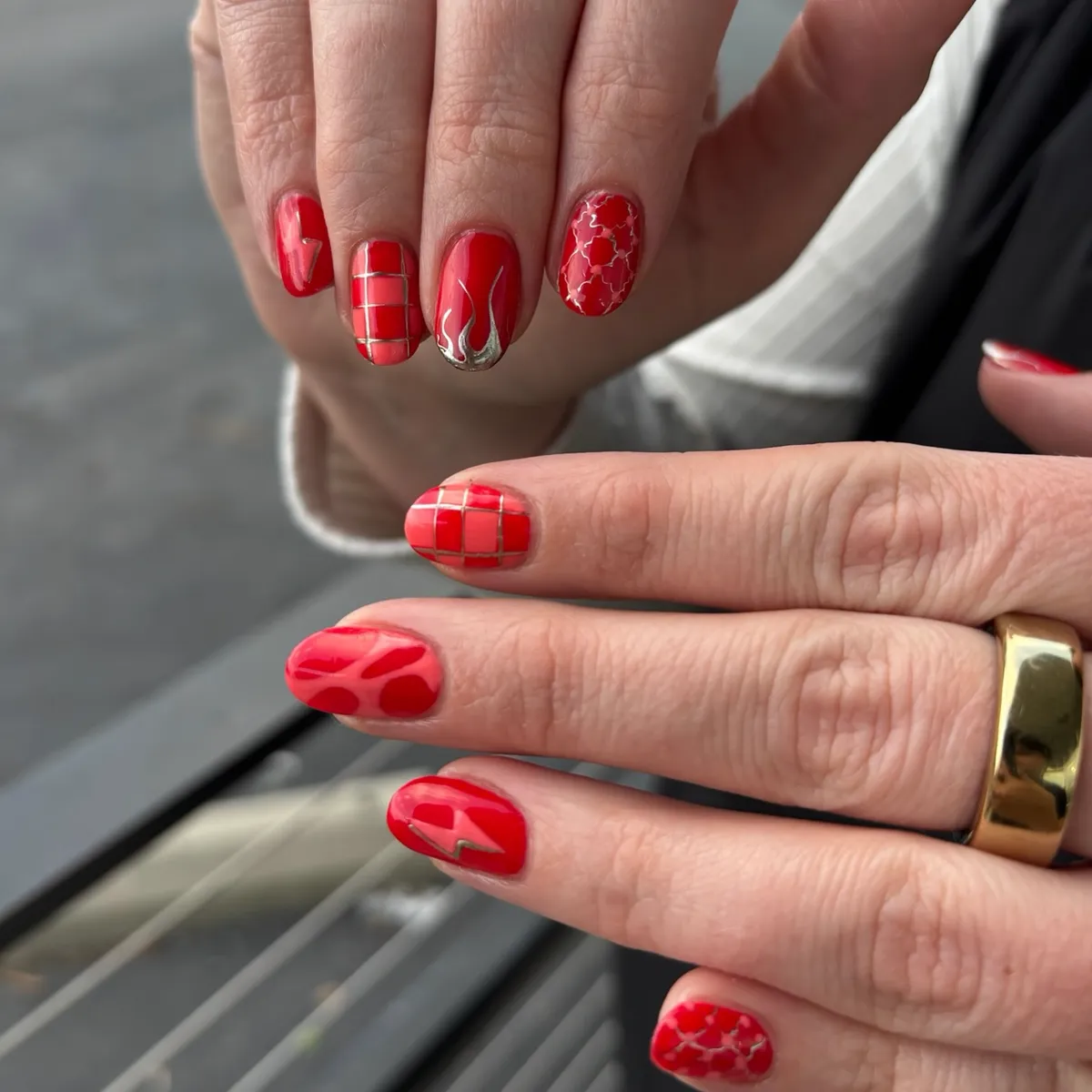 Bright red nails with glossy sculpted three-dimensional detail